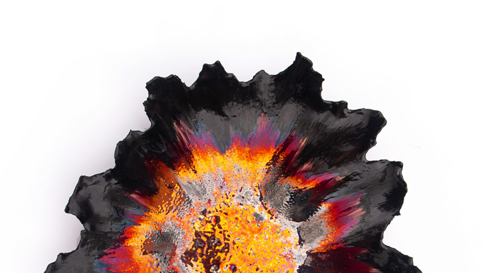 A dramatic macro close-up of dynamic luster glaze texture on a ceramic vessel by Alireza Rostami, showing vivid explosion of golden yellow, fiery orange, and iridescence purple hues meeting a jagged dark border.